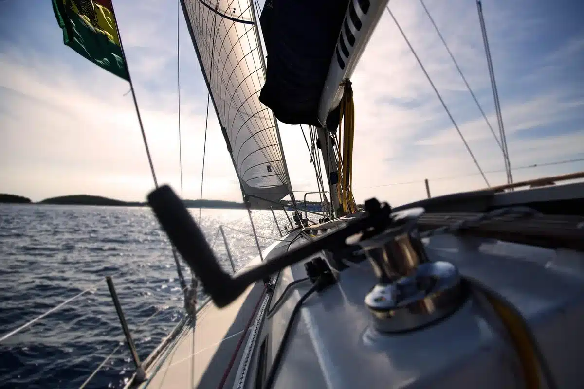 A live-action pirate ship deck with a young captain and crew setting sail